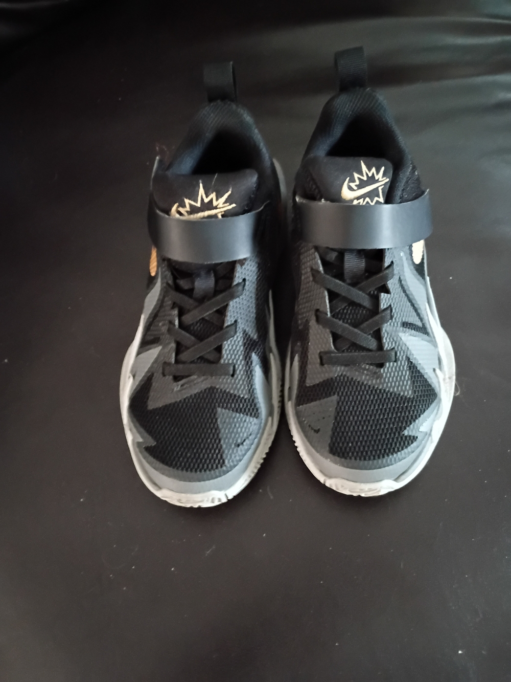 Nike Kids Black and Gray Sneakers with Gold Accent
